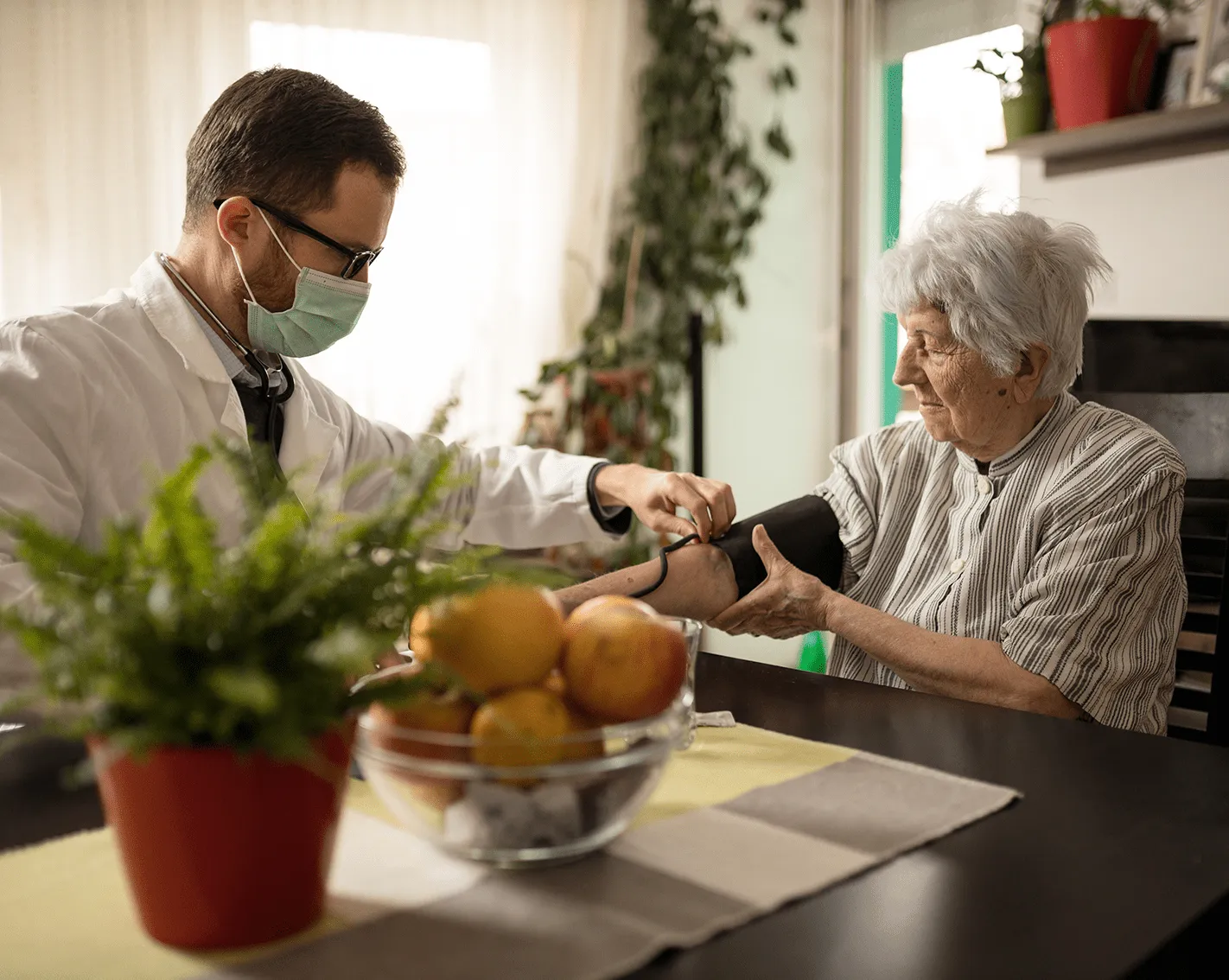 Doctor helping elderly woman